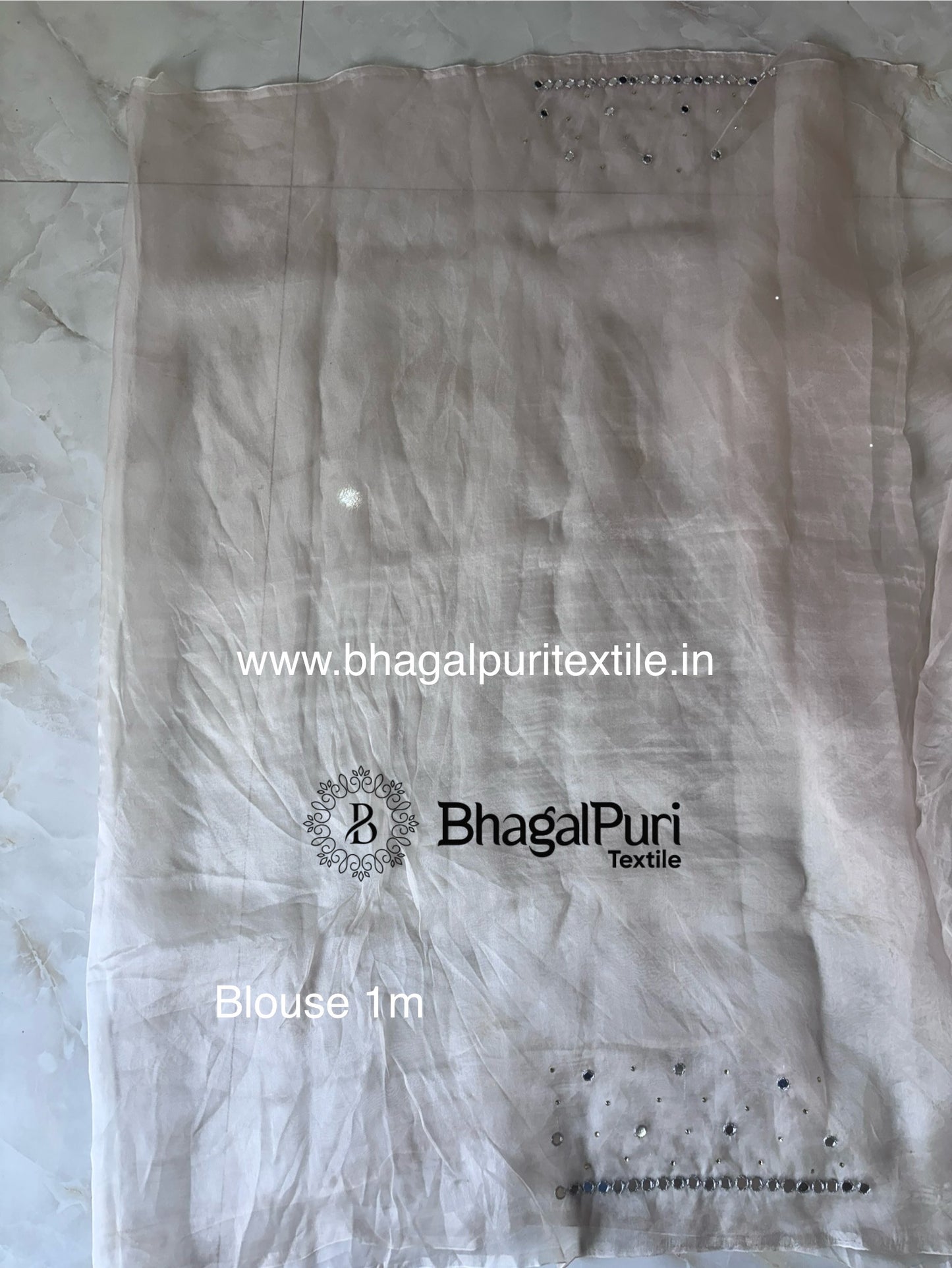 Elegant organza saree with zari sparkle detailing and mirror embroidery, perfect festive wear with blouse piece.