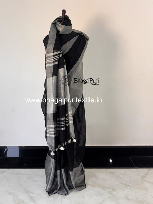Classic black linen saree with designer silver zari broad border for festive and party wear.