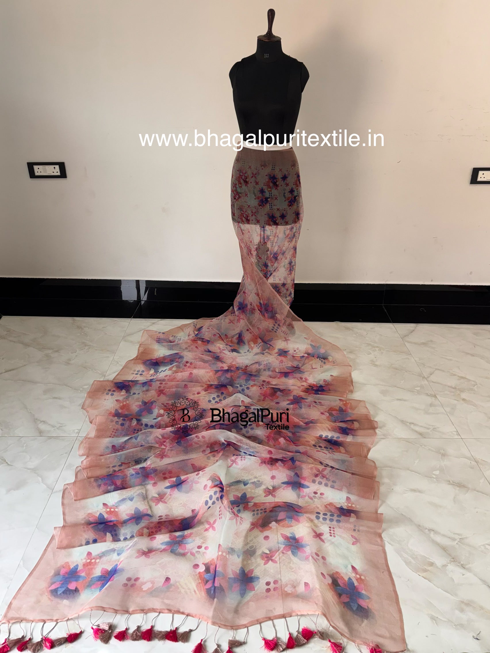 Model wearing organza digital print saree with flowing pallu and contemporary floral design