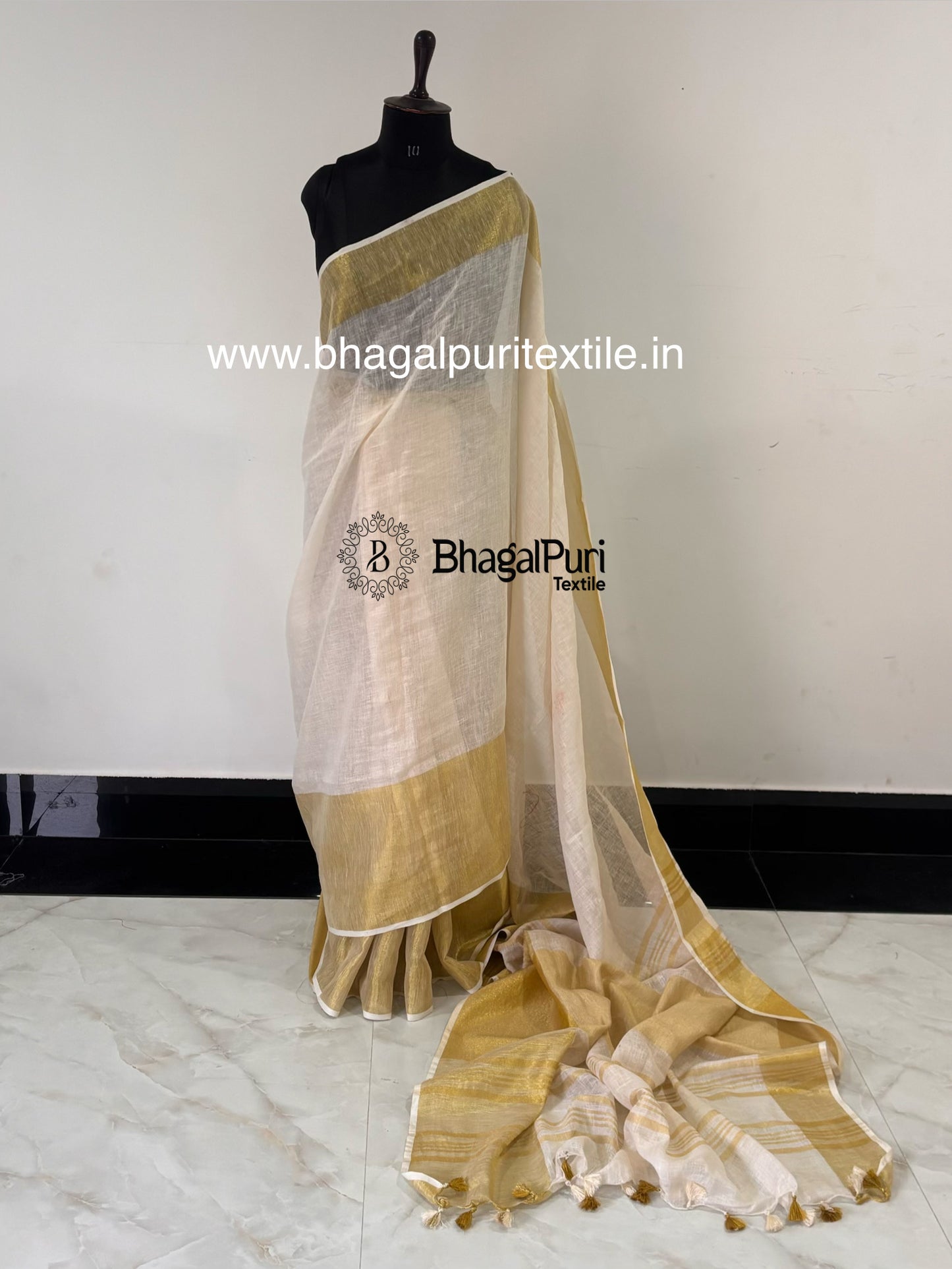 Elegant white linen saree featuring luxurious golden Mahapad border with classy ethnic style