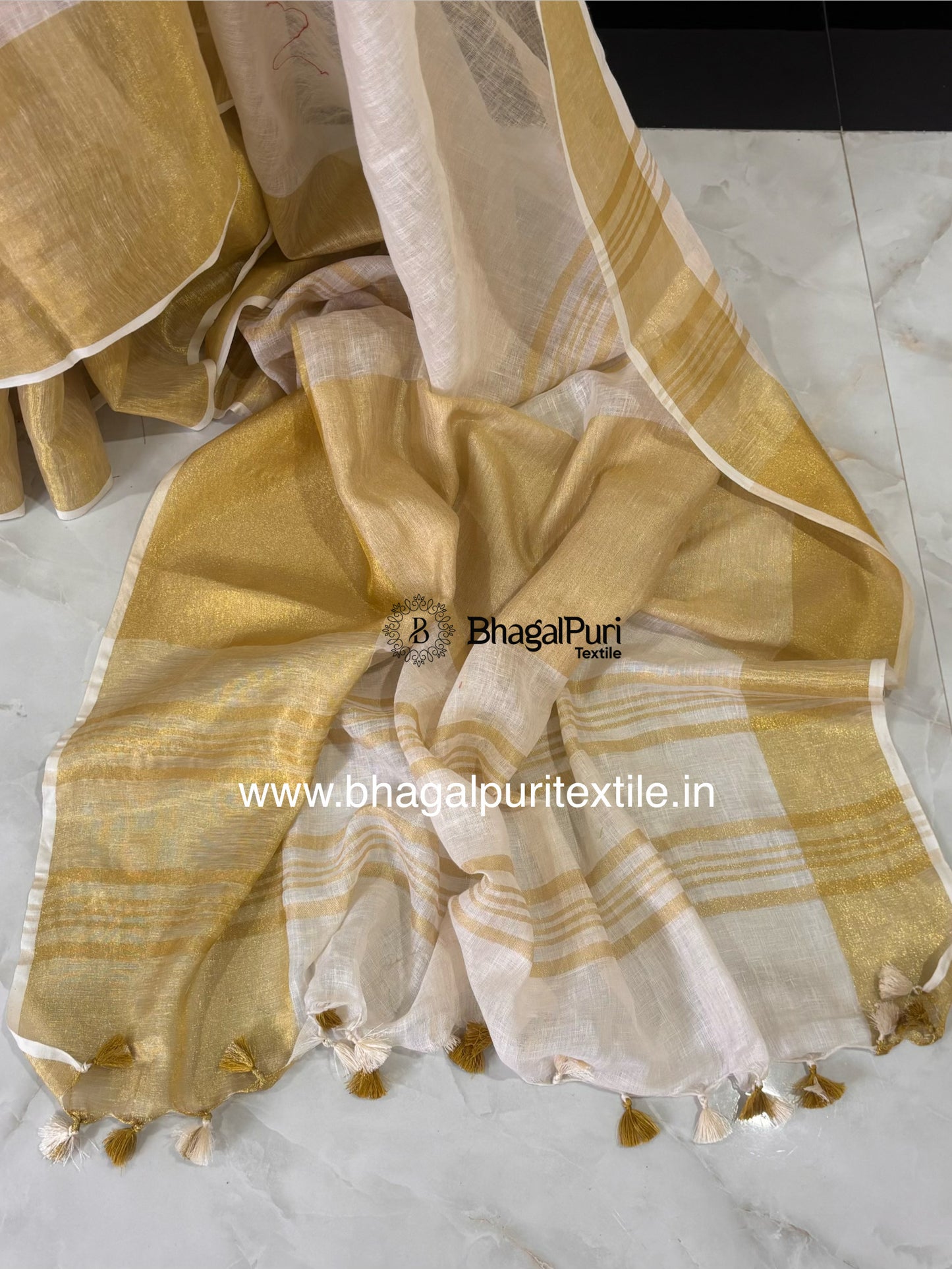 Soft white linen saree with rich golden Mahapad border perfect for festive and wedding wear