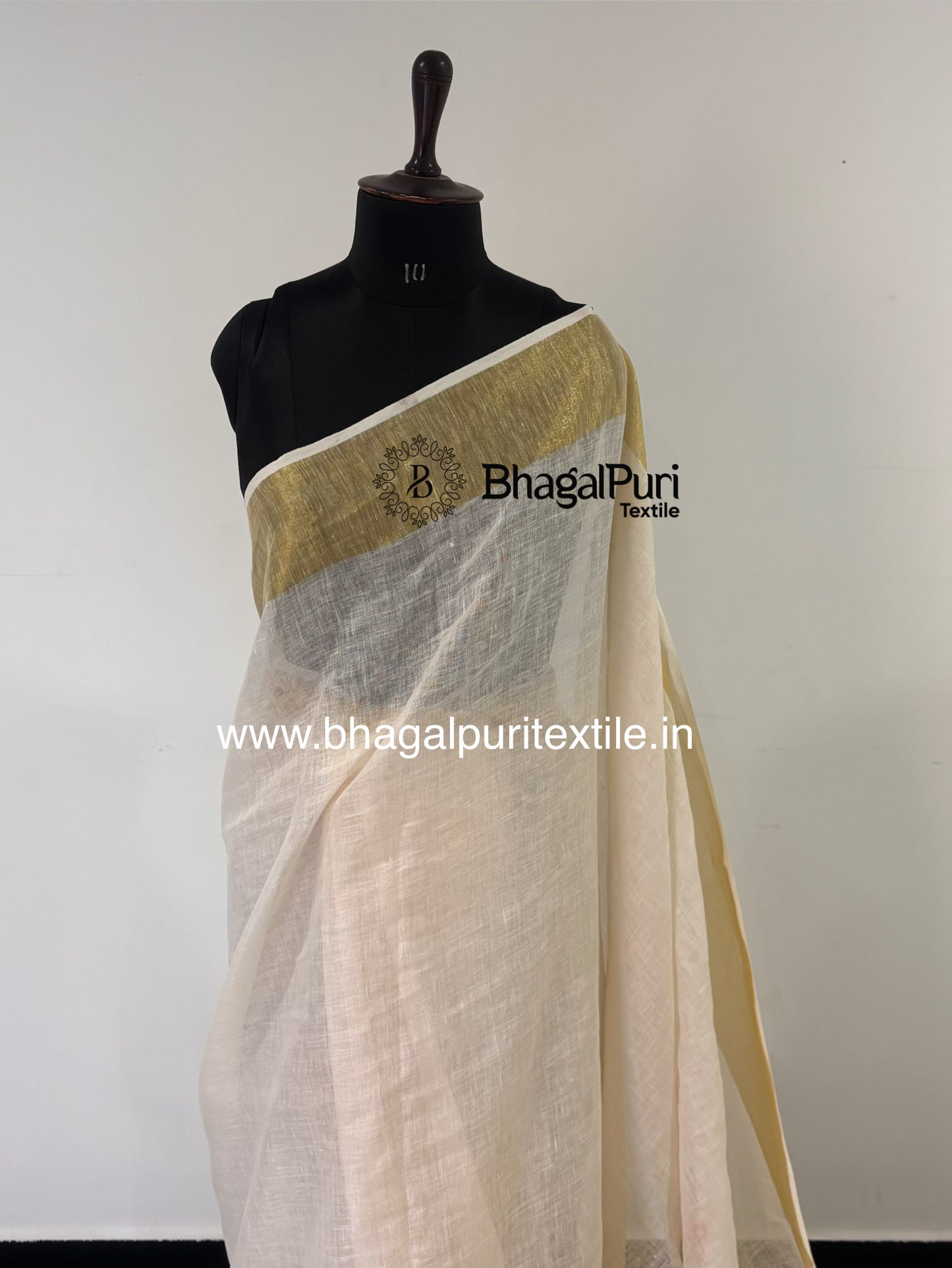 Premium ivory white linen saree with broad golden Mahapad border and sophisticated drape