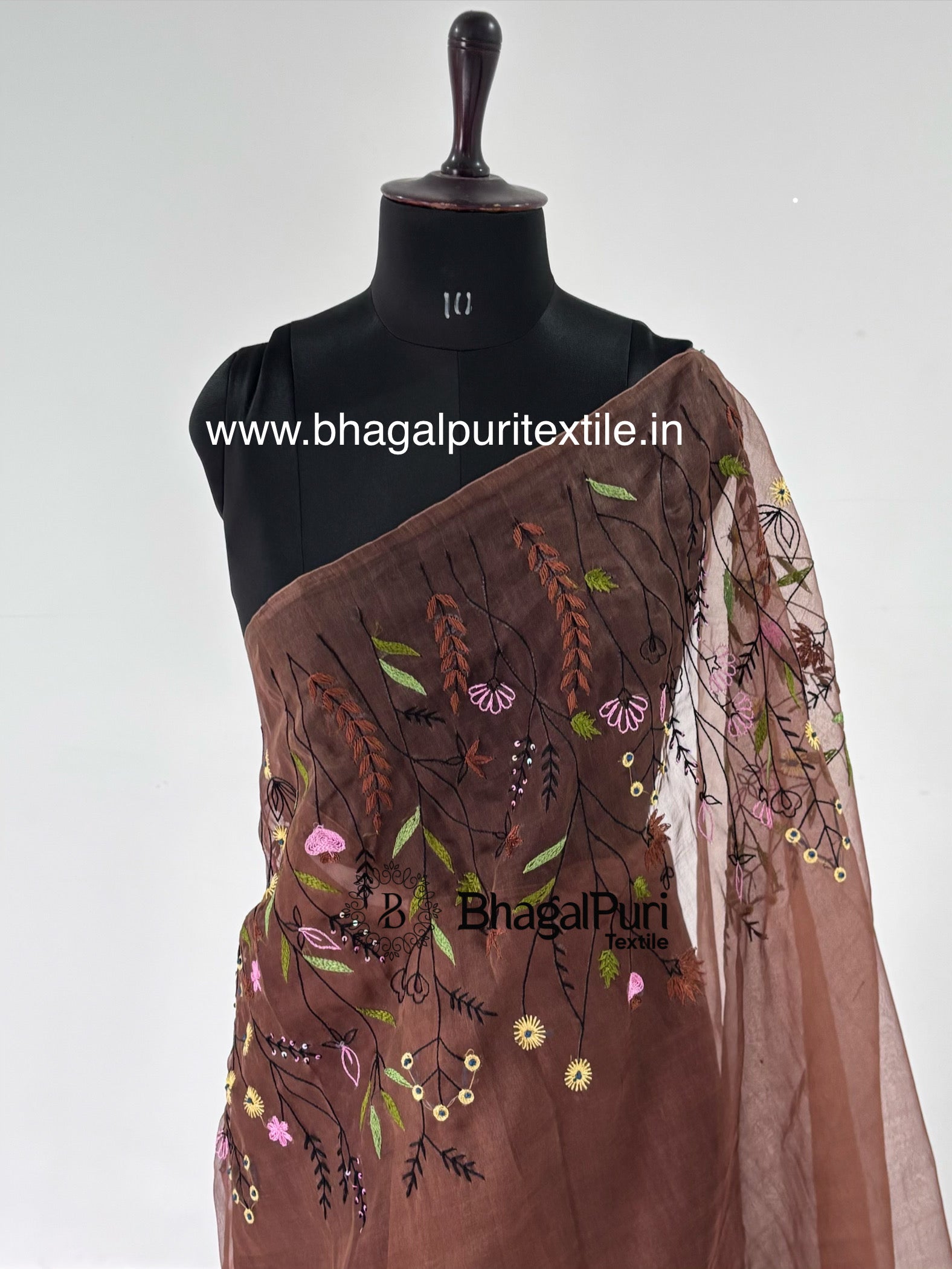 Premium coffee brown organza saree featuring intricate hand embroidery and stylish designer border for festive and ethnic occasions.