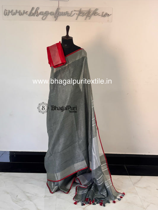 Smoky grey linen saree designed with classy red piping border and minimal elegant look for occasions.
