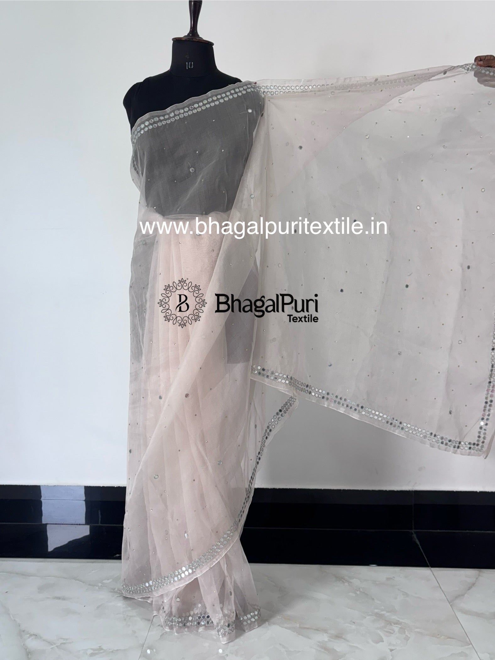 Designer organza saree featuring zari sparkle and mirror work, perfect for festive occasions and celebrations.