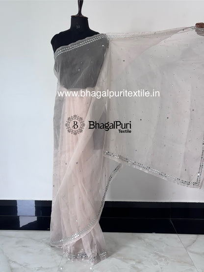 Designer organza saree featuring zari sparkle and mirror work, perfect for festive occasions and celebrations.