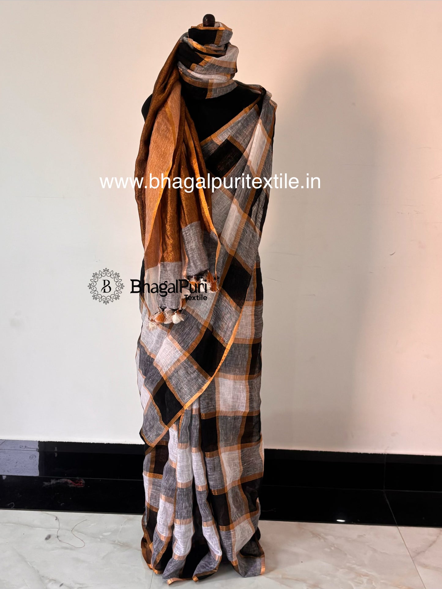 Elegant black and white linen saree with check design and rich zari border for women