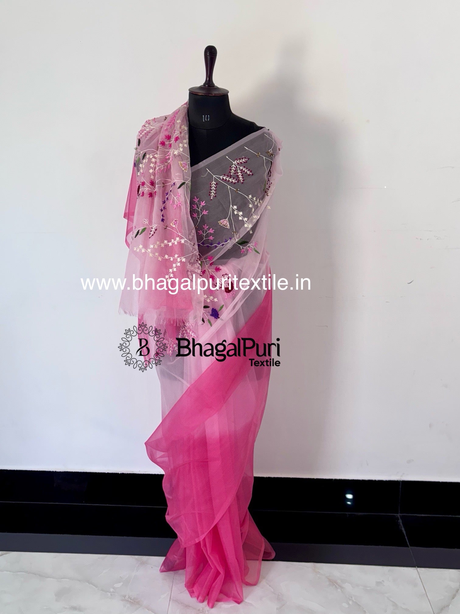 Pure organza silk saree in white and pink with delicate embroidery work, ideal for festive and elegant occasions.
