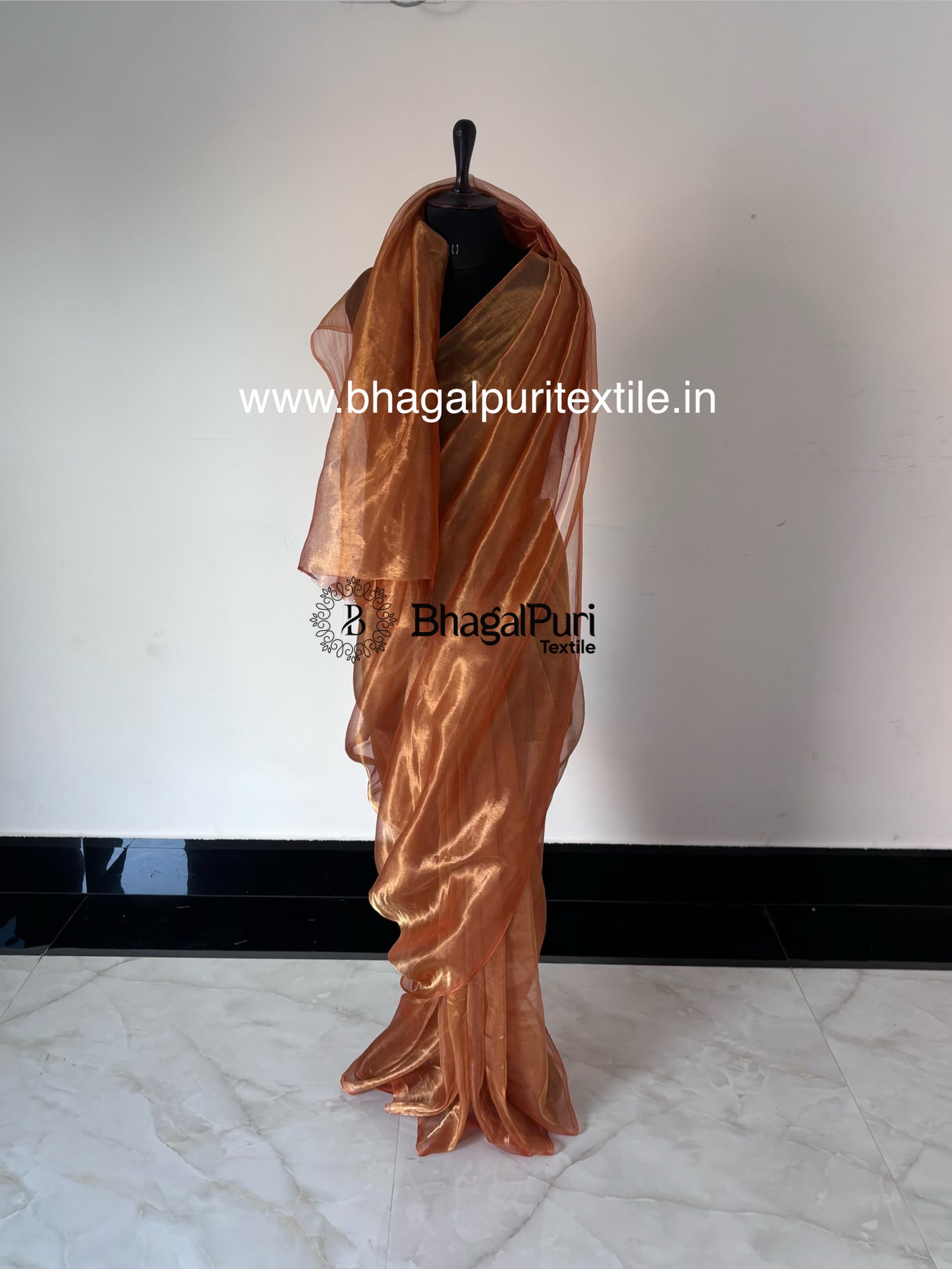 Velvya sunset orange tissue silk saree with elegant shimmer, designer tissue silk saree for wedding and festive wear.
